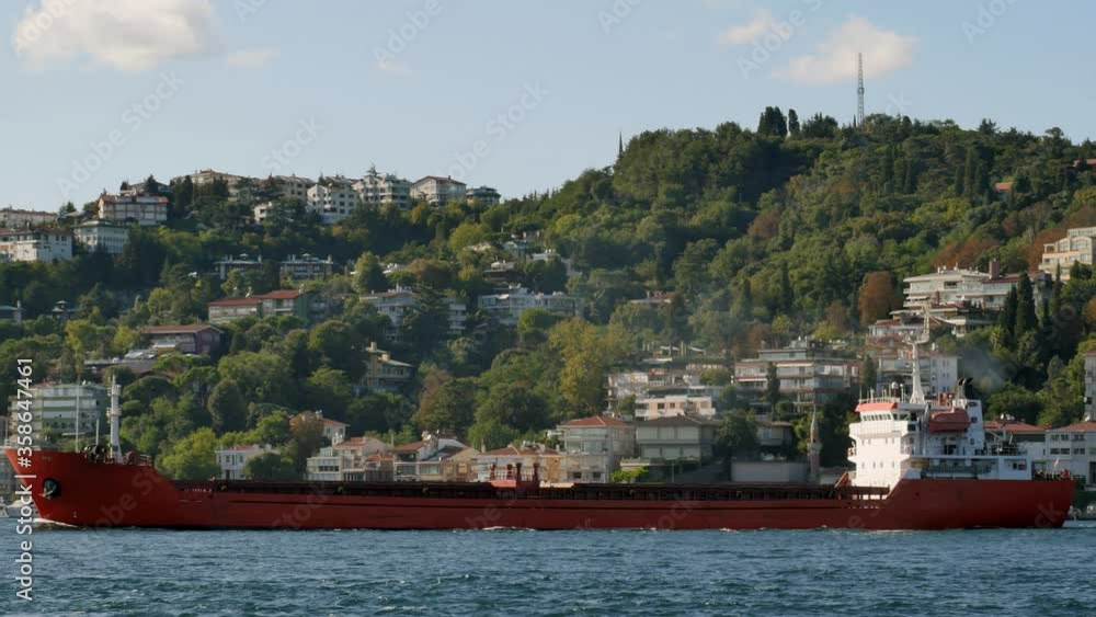 Red freighter cruising on the Bosporus Straits in Istanbul. 4K tracking telephoto shot. Some 50,000 ships pass through the Turkish Straits every year
Red freighter cruising on the Bosporus Straits in Istanbul. 4K tracking telephoto shot. Some 50,000 ships pass through the Turkish Straits every year