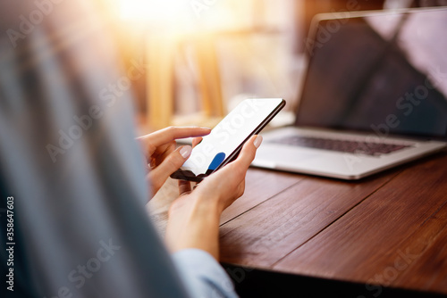 Woman pointing on smartphone screen, chatting in social networks, meeting website, searching internet, sending sms, using text messenger or online banking