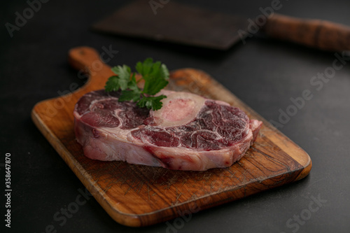 Slice of raw beef shank on a cutting board