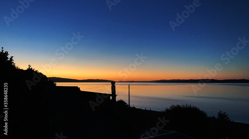 Sunset near the sea in Ancud, Chile photo