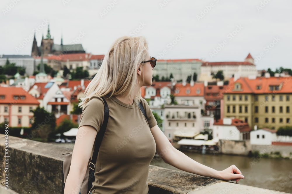Blonde woman at Charles bridge in Prague, Czech Republic