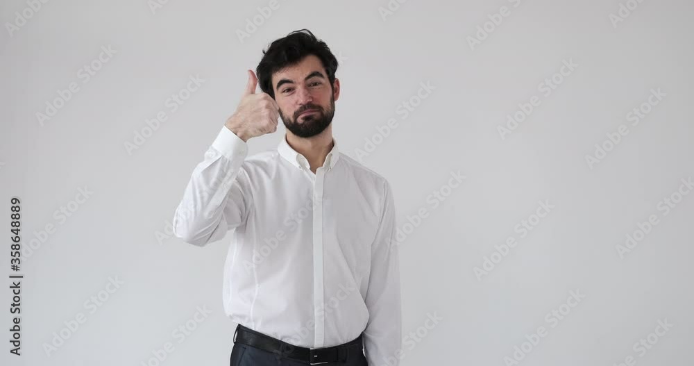 Confident businessman giving thumbs up gesture over white background Confident businessman giving thumbs up gesture over white background