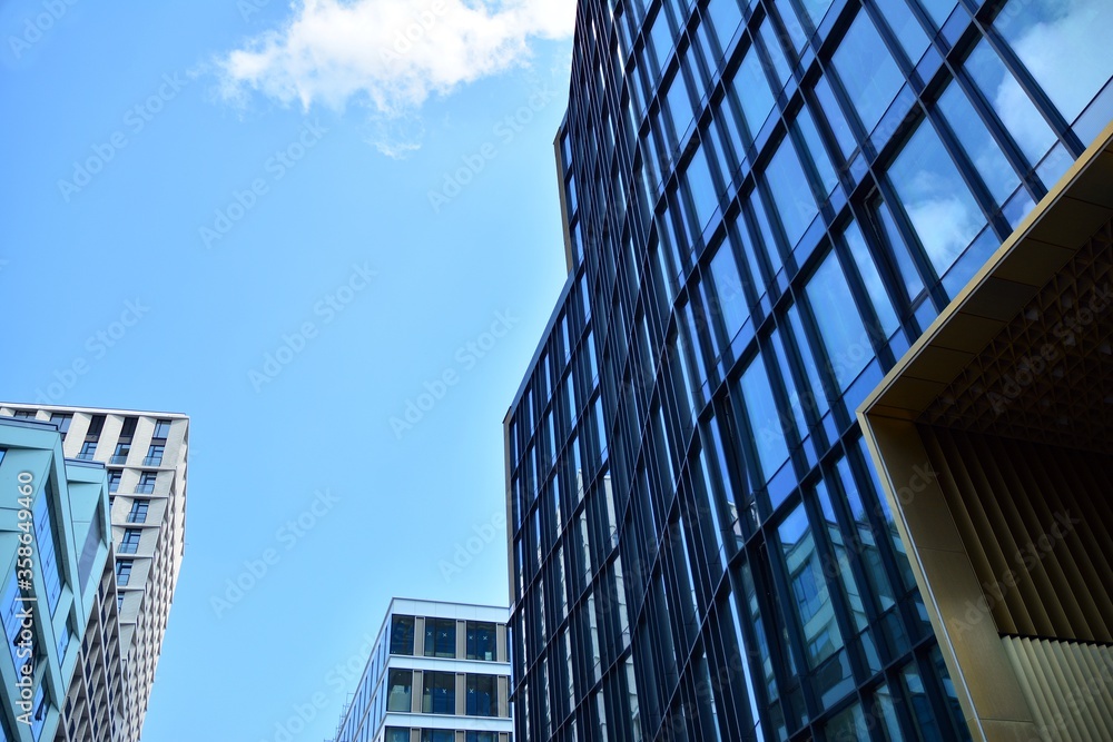 Facade texture of a glass mirrored office building. Fragment of the facade. Modern architecture of the office building. Facade texture of a glass mirrored office building. Fragment of the facade. Modern architecture of the office building.
