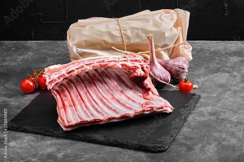 Lamb ribs fresh meat, with eco-friendly packaging. Food Delivery Concept. copy space, dark background