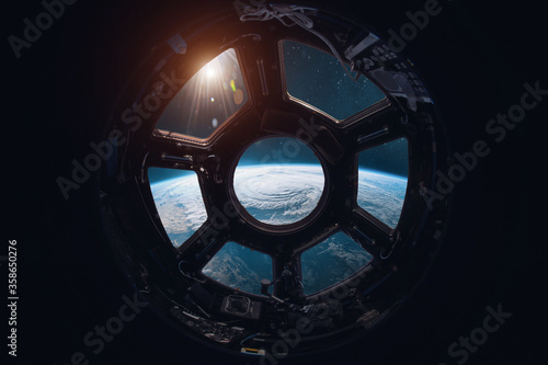 Fototapeta Naklejka Na Ścianę i Meble -  View on Earth planet from ISS station porthole. Space and sun. Elements of this image furnished by NASA