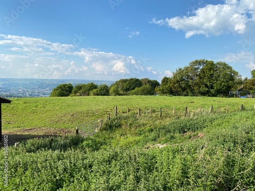 Landscape view of a large field, with trees, and fencing, on a sunny day in, Bradford, Yorkshire, UK