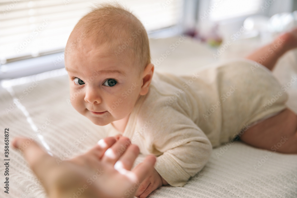 The baby learns to hold its head and lies on its stomach. The benefits