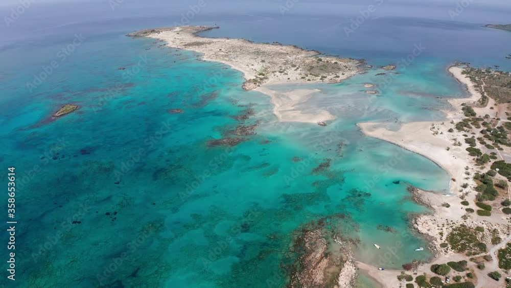 Exotic beach drone flyover with crystal clear blue turquoise water in Crete, Greece