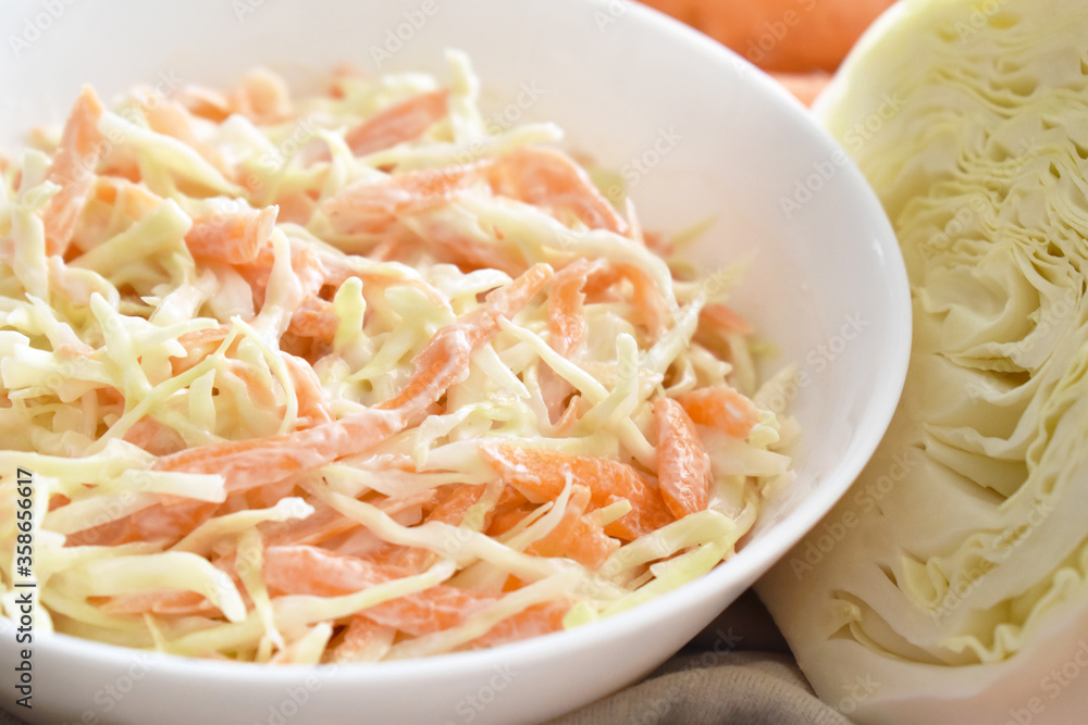 Coleslaw salad with cabbage and carrot. Healthy and dietary food concept. Coleslaw salad with cabbage and carrot. Healthy and dietary food concept.