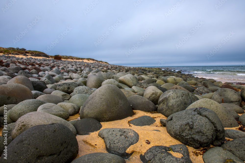 black pebbles on sandy beach iceland west fjords