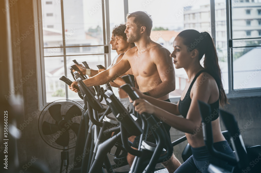Side view of attractive sports people group on running track, Young people running on a treadmill in health club gym. Side view of attractive sports people group on running track, Young people running on a treadmill in health club gym.