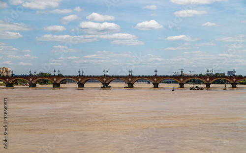 Panoramic view of the old stone bridge Pont de Pierre over the river Garonne in Bordeaux.