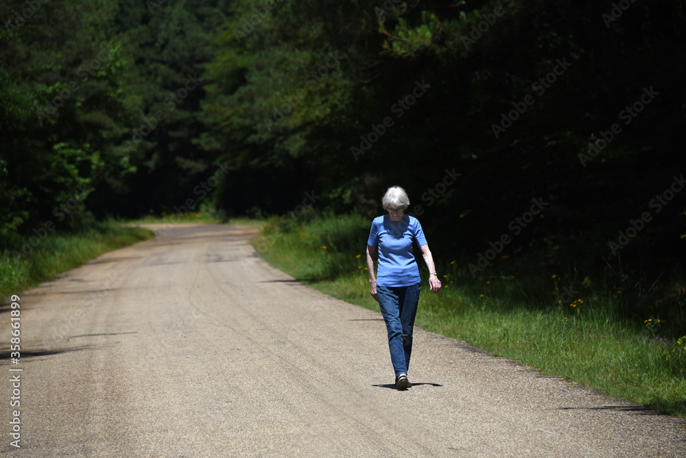 Fototapeta premium Elderly Woman Walks for Exercise