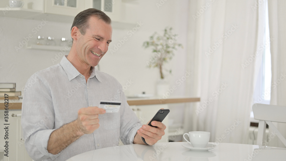 Online Shopping on Smartphone by Happy Middle Aged Man Online Shopping on Smartphone by Happy Middle Aged Man
