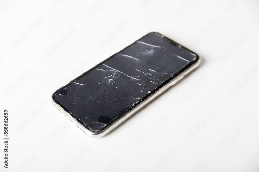 Broken phone on white background Broken phone on white background