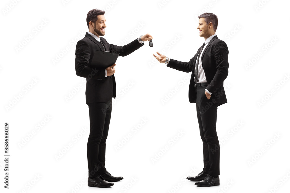 Full length profile shot of a businessman giving car keys to a man Full length profile shot of a businessman giving car keys to a man