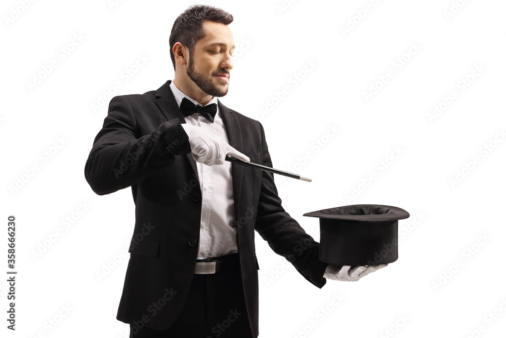 Magician performing a trick with a magic wand and a top hat - obrazy, fototapety, plakaty 