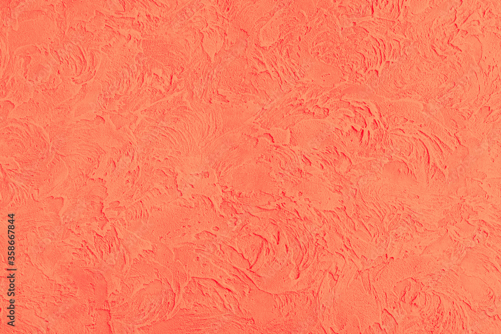 A background of the raised red wall is finished with decorative plaster. Abstract streaks like waves on a concrete wall. Design renovation of old housing and commercial real estate. A background of the raised red wall is finished with decorative plaster. Abstract streaks like waves on a concrete wall. Design renovation of old housing and commercial real estate.