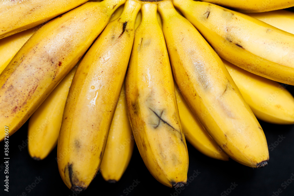 Natural fresh banana close-up on a black background.