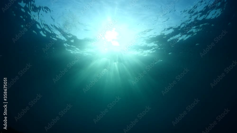 sun ray and sun beam scenery underwater waves on surface of water slow ocean scenery backgrounds sun ray and sun beam scenery underwater waves on surface of water slow ocean scenery backgrounds