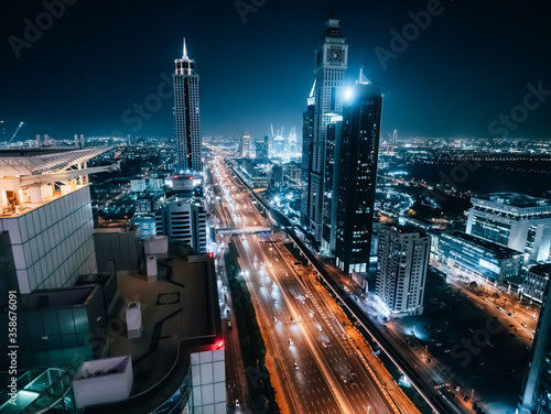 Dubai skyline at night, urban skyscrapers and car traffic, view from above, United Arab Emirates.