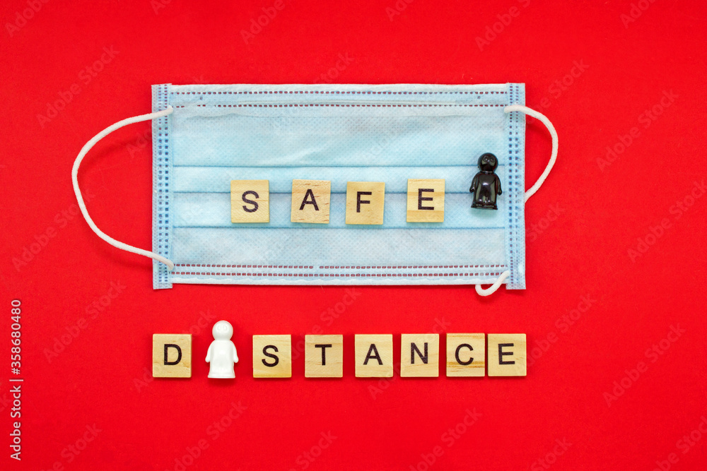safety concept during the corona virus pandemic. medical mask, people and the inscription safe distance safety concept during the corona virus pandemic. medical mask, people and the inscription safe distance