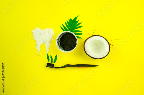 coconut charcoal tooth powder, the concept of healthy teeth and dentistry, natural environmental products for oral hygiene