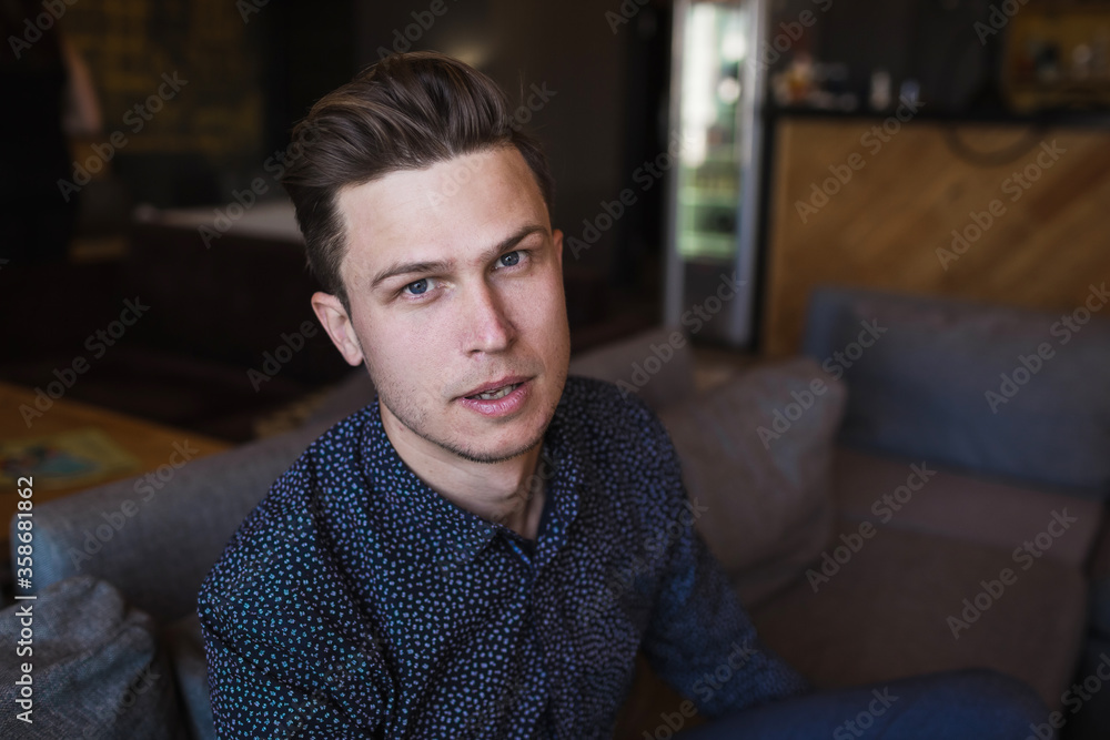 The young man is in a modern stylish cafe. The young man is in a modern stylish cafe.