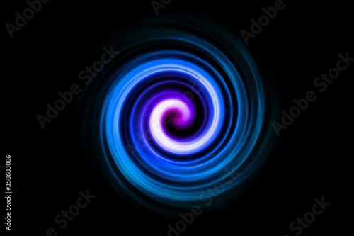 Blue fire light flying in circle with purple lights in motion on black sky background