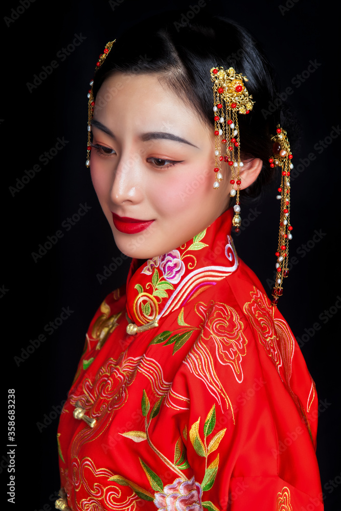 Women in Asian red costume on black background