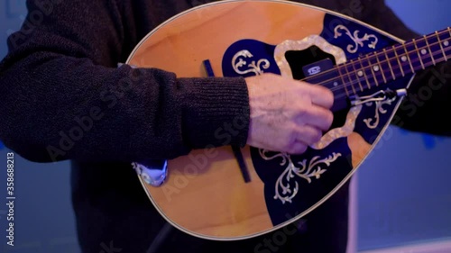 Fluent playing chords on a electrical mandoline closeup photo