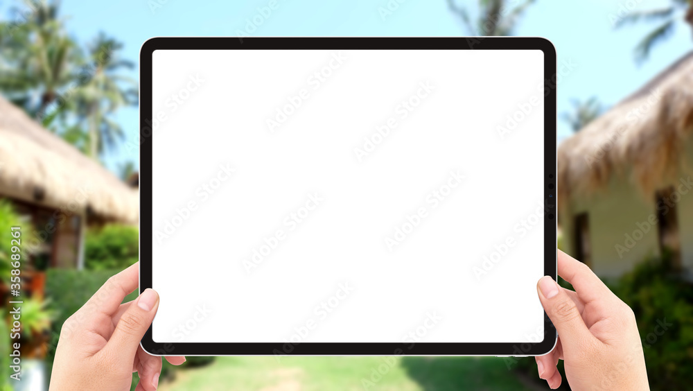 Human two hands holding tablet computer white screen mockup in resort Human two hands holding tablet computer white screen mockup in resort