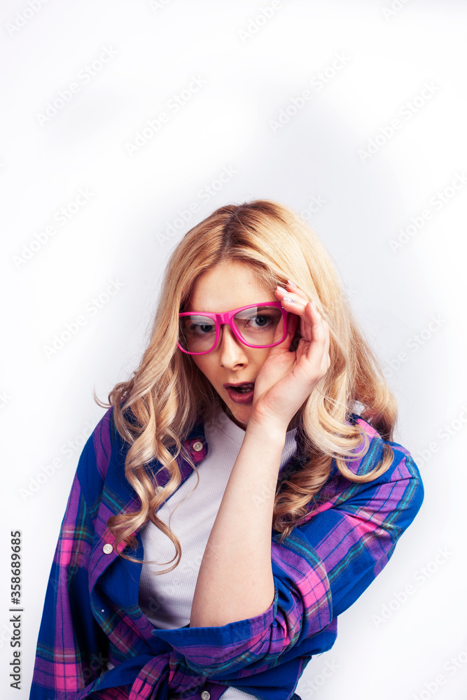 Fototapeta premium young pretty blond teenage hipster girl in glasses posing emotional happy smiling, gesturing isolated on white background, lifestyle poeple concept