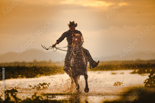 Silhouette Cowboy on horseback. Ranch © PK Studio