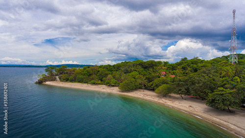 Aerial drone view of an empty white sandy beach in tropical Sumbawa, Indonesia