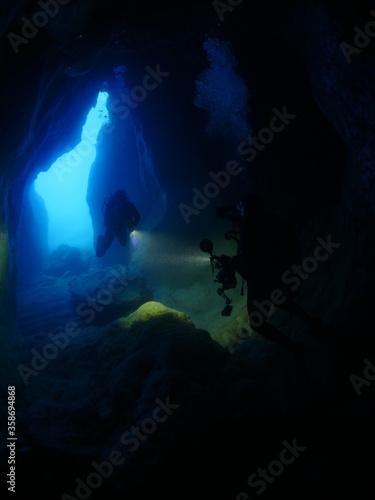 cave diving underwater scuba divers exploring cave dive ocean scenery © underocean