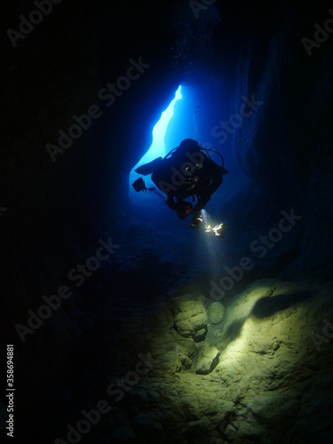 cave diving underwater scuba divers exploring cave dive ocean scenery