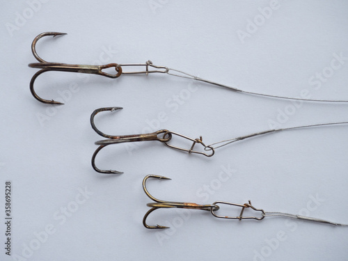 Three big fishing hooks with steel lines photo