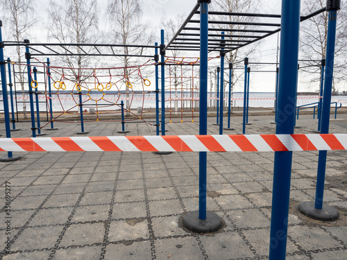 Playground with fitness equipment in Petrozavodsk (northwest of Russia) fenced with tape during quarantine for coronavirus infection COVID-19