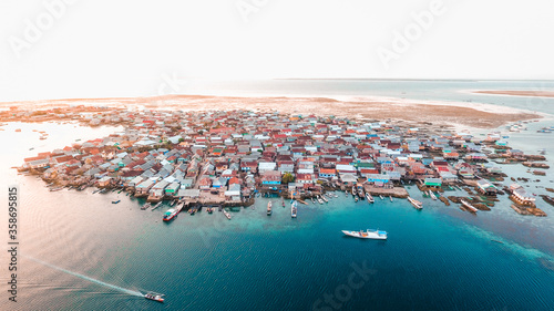 Aerial view of Bungin Island in Sumbawa, Indonesia. The most populous island of fisherman village. Traditional wooden house.