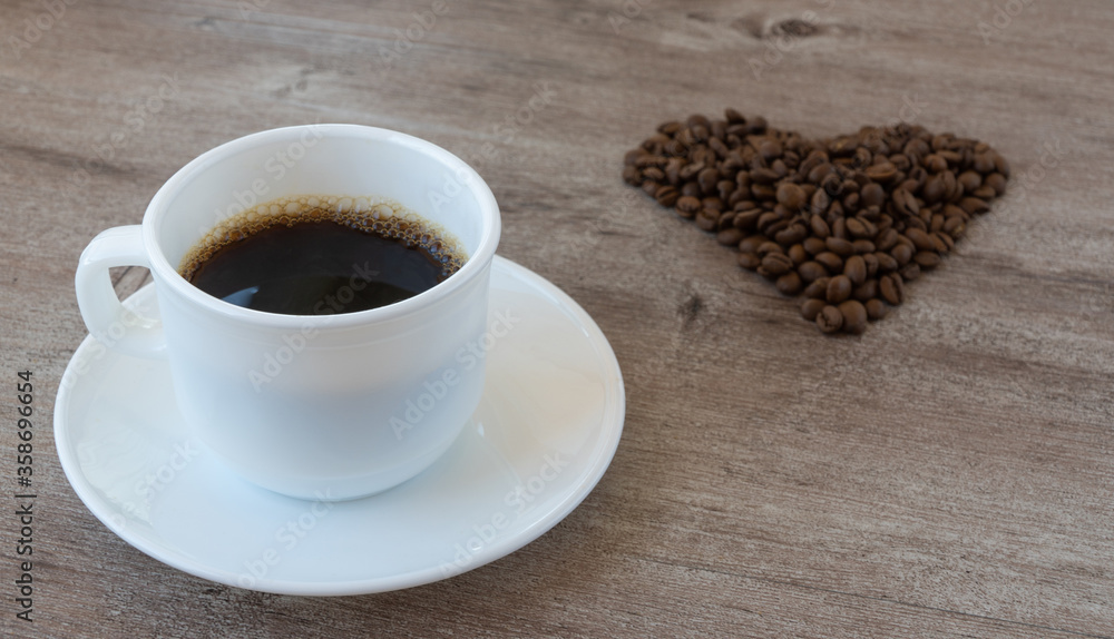 making coffee. Cup of fragrant coffee. beans are laid out in the shape of a heart. making coffee. Cup of fragrant coffee. beans are laid out in the shape of a heart.