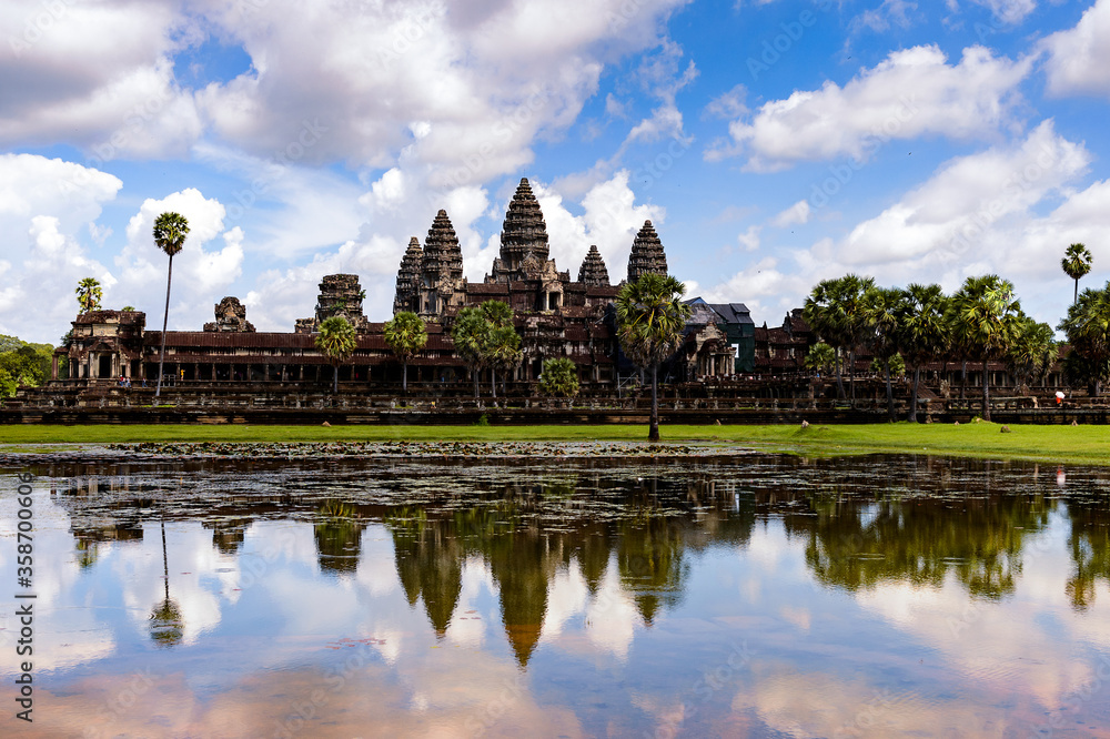 It's Angkor Wat (Temple City) and its reflection in the lake, a Buddhist, temple complex in Cambodia and the largest religious monument in the world. View from the garden