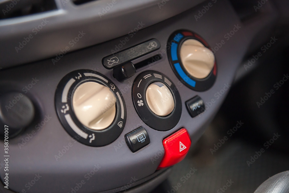 Air conditioning button inside a car. Climate control unit in the old car. Old car interior details. Car detailing. Selective focus.