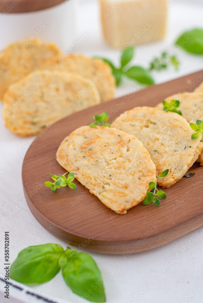 home made cheese crackers with herbs on a table home made cheese crackers with herbs on a table