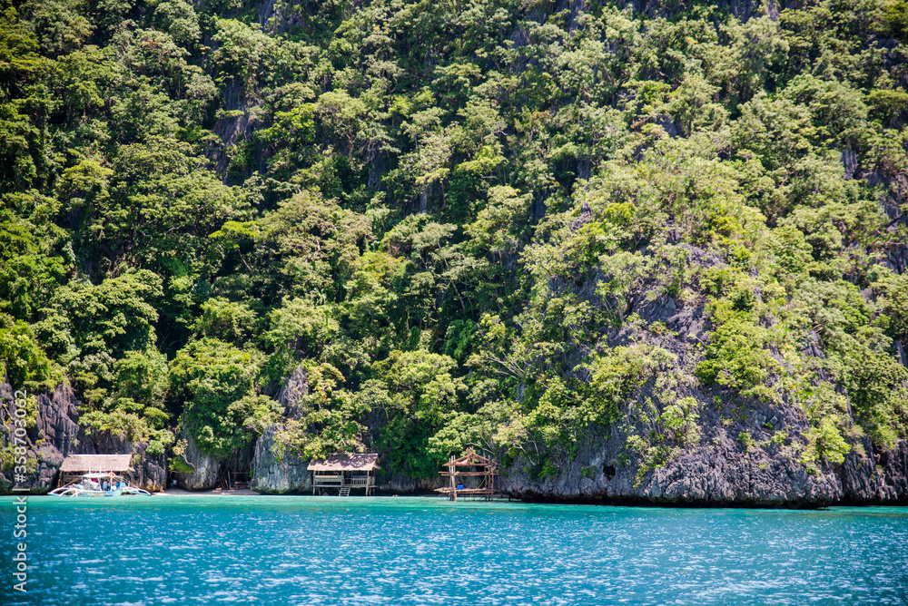 Private cottages in white sand beach  with majestic limestone wall in the back