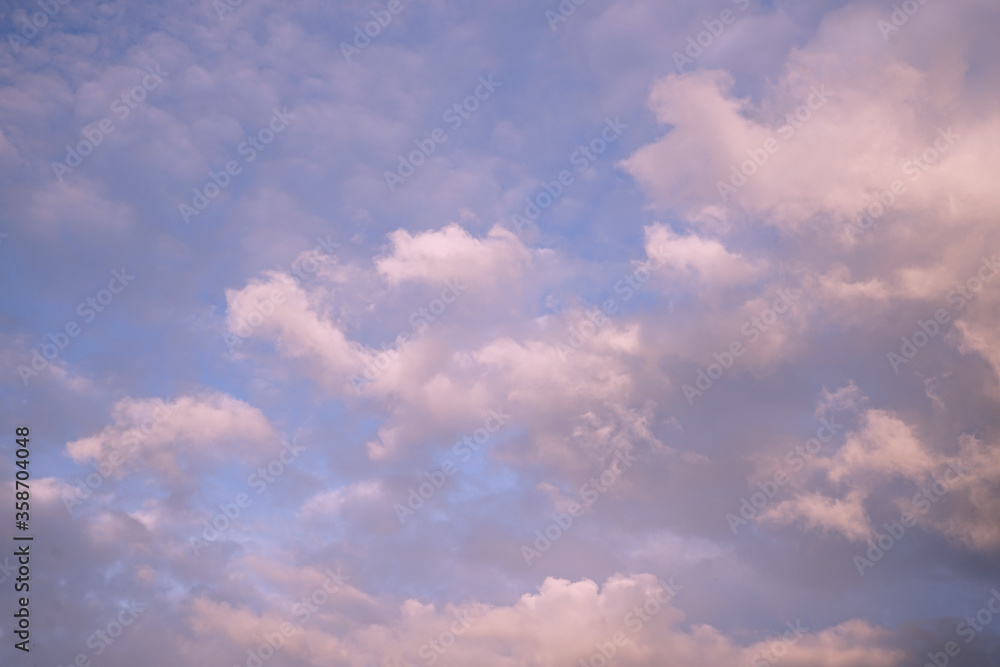 Blue sky with clouds. Сloudscape. Sky at sunset landscape background. Gently pink sunset.