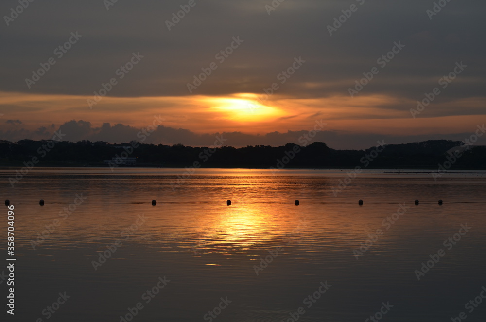 View of the Sunset with the lake and clouds View of the Sunset with the lake and clouds