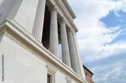 facade of a building with columns depicting roman architecture