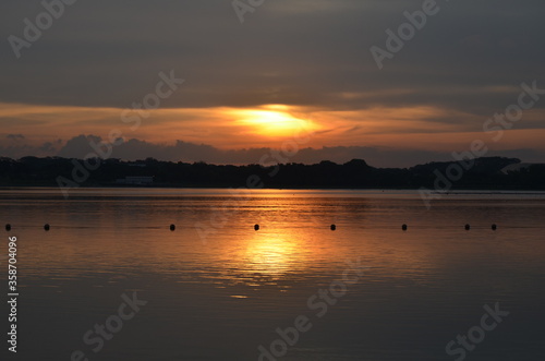 View of the Sunset with the lake and clouds