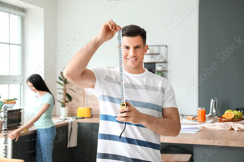Young man with measuring ta...